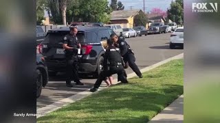 Police officers stop fellow officer punching handcuffed woman during arrest [upl. by Wheeler]